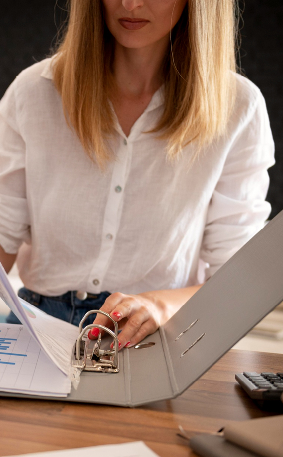 Team member organizing records — dedicated payroll team providing payroll compliance support